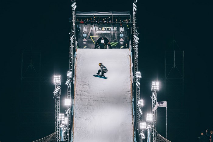 Snowboarder performing a jump at Air + Style Los Angeles 2017