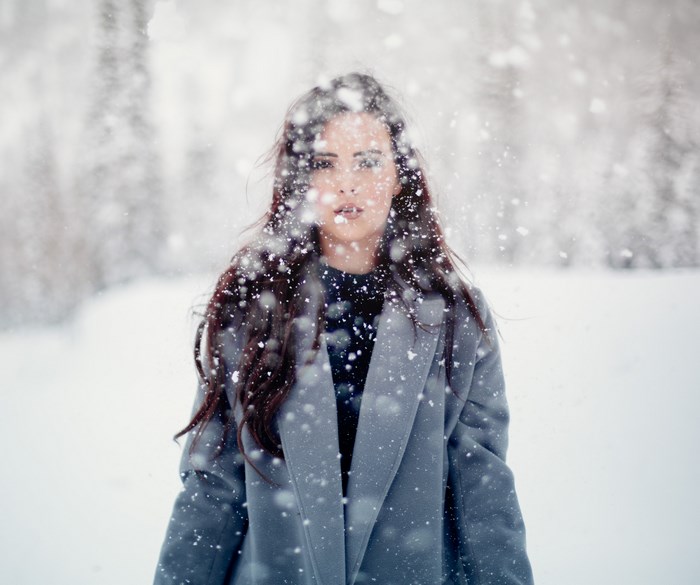 Woman in a gray coat in the snow