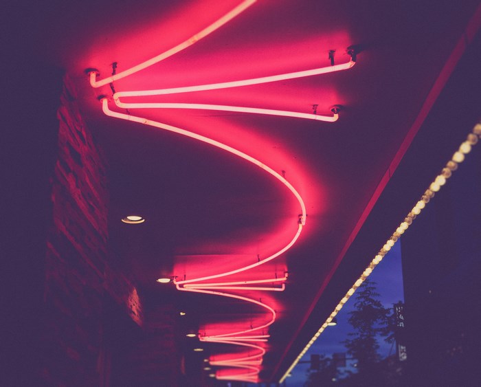 Red Neon Sign Above Building