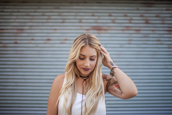 Woman with blonde hair and tattoos