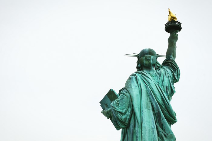 Statue of Liberty's back with torch and book