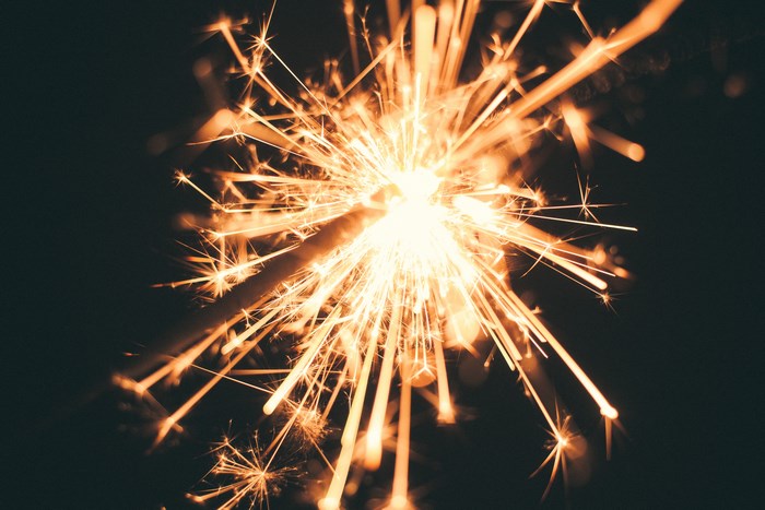 Close-up of a bright orange sparkler