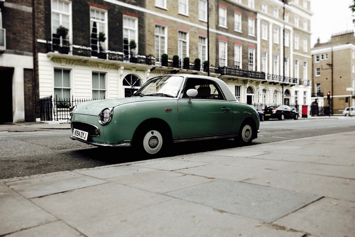 Vintage turquoise Nissan Figaro parked on a London street
