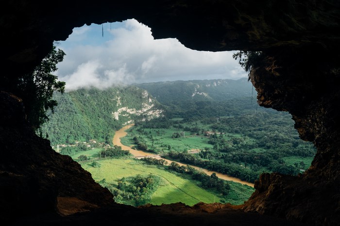 View of a river valley from a cave opening