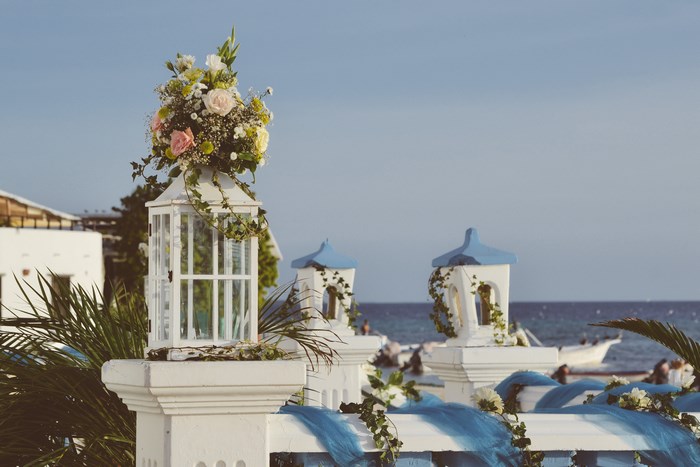 Wedding decorations with flowers and lanterns by the sea