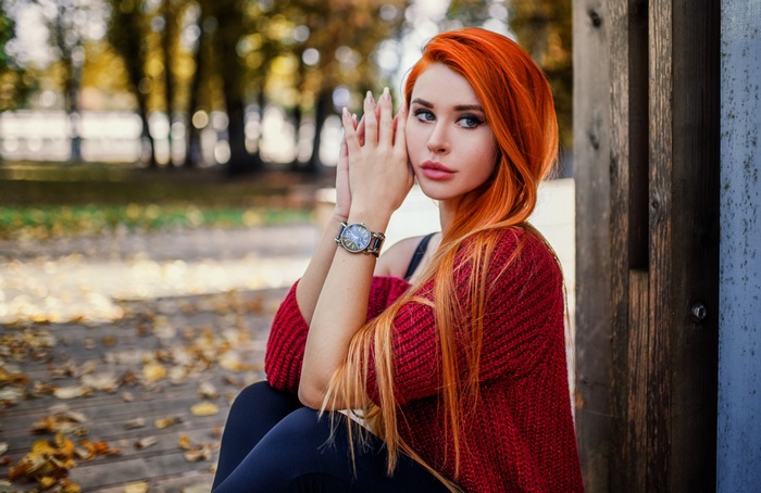 Woman with long orange hair and blue eyes