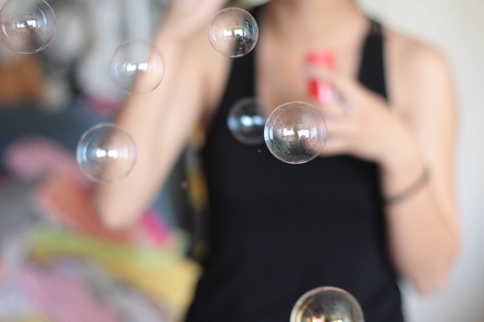 Woman blowing bubbles