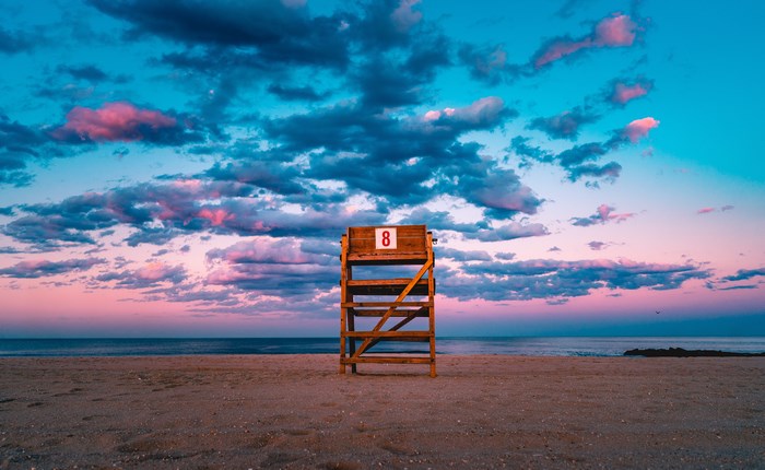 Lifeguard tower number eight on a beach at sunset