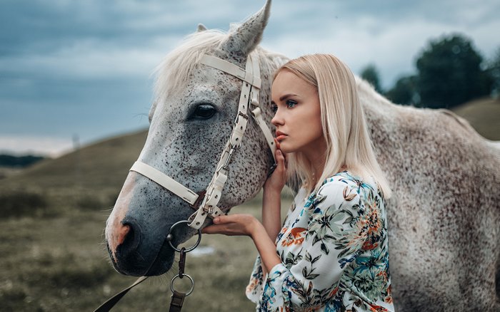 Blonde woman with a white horse