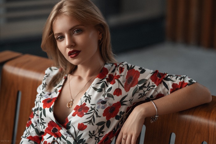 Woman with blonde hair wearing a floral dress