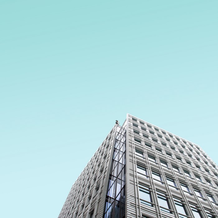 Modern building with glass facade against a clear sky