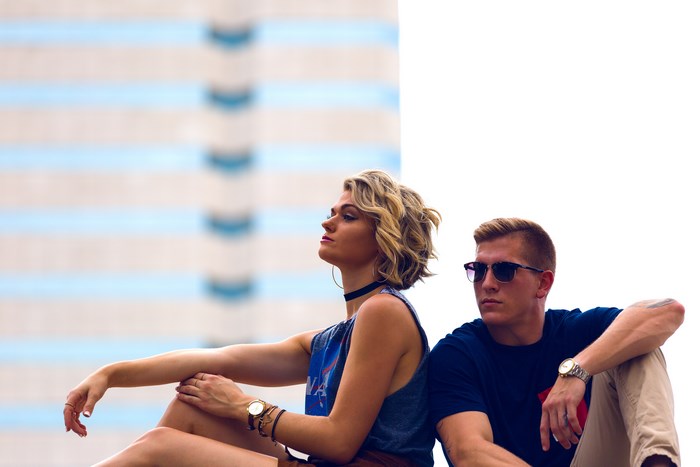 Man and woman sitting in front of a building
