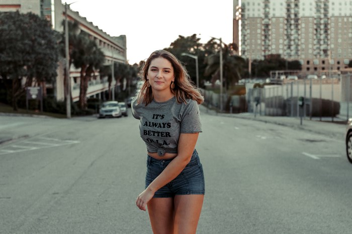 Woman wearing a t-shirt that says "It's Always Better in LA"