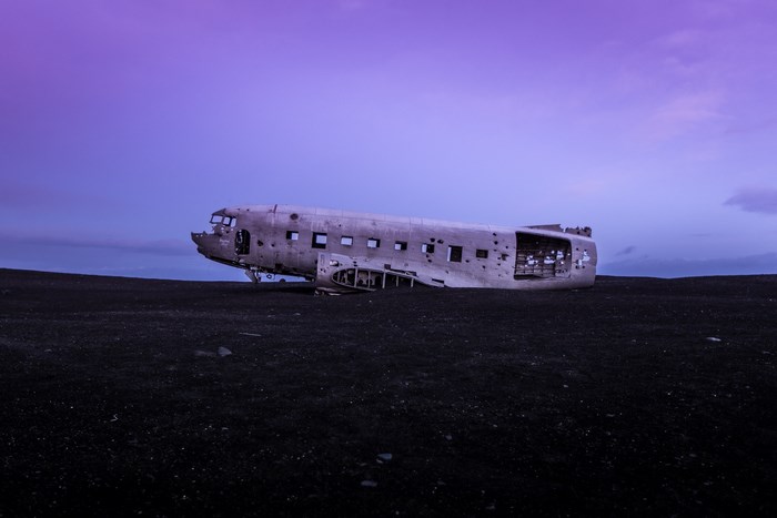 Abandoned airplane wreck on black sand beach in Iceland