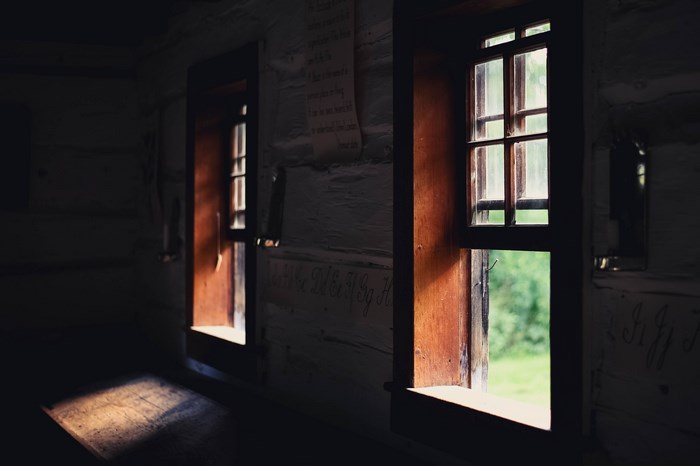 Interior of an old wooden house with two windows