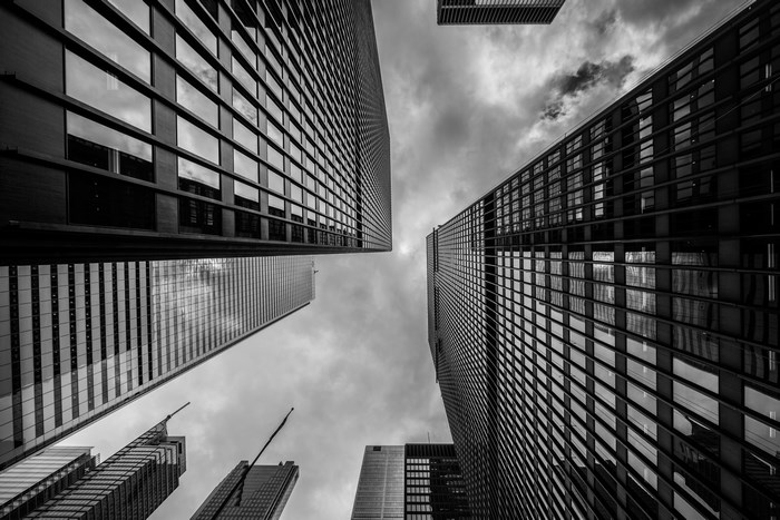 Looking up at skyscrapers on a cloudy day