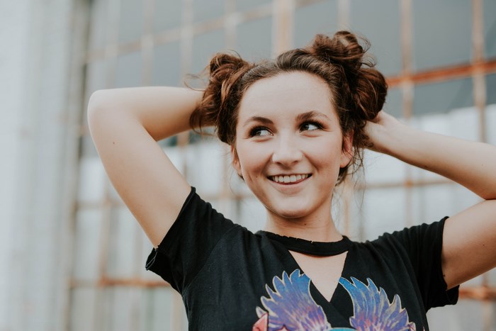 Woman with space buns smiling