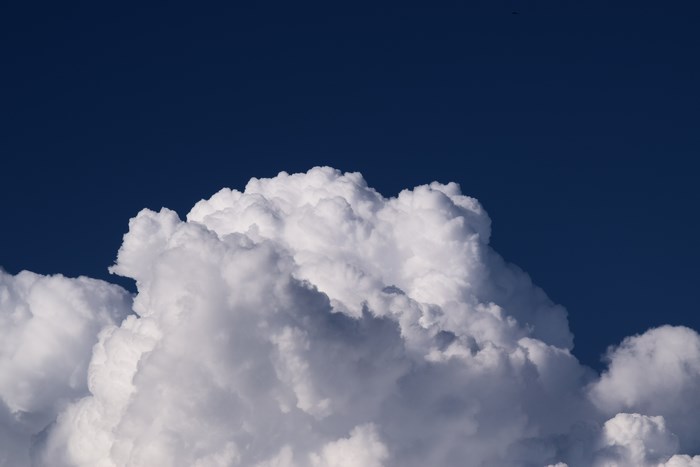 Dramatic Cumulonimbus Cloud Against Deep Blue Sky