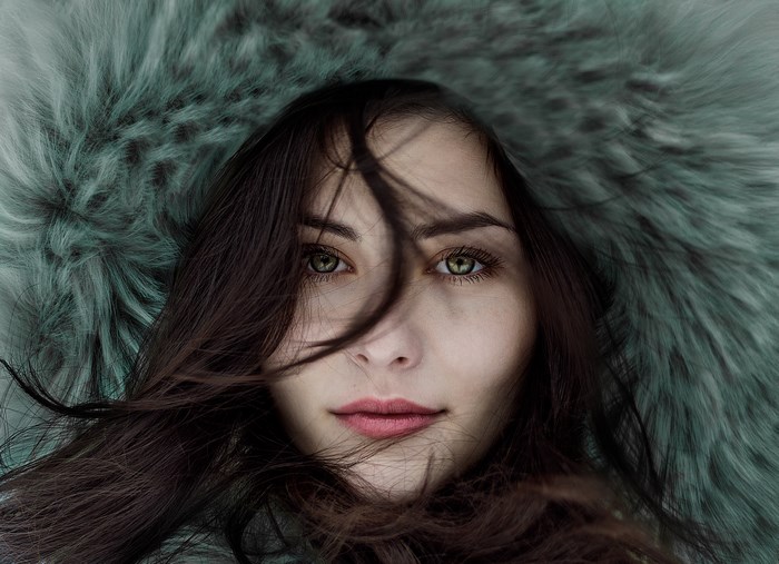 Woman with green eyes and fur hood