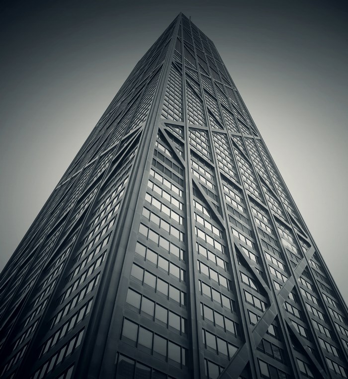 Black and white angled view of a modern skyscraper