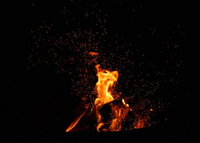Campfire with sparks at night