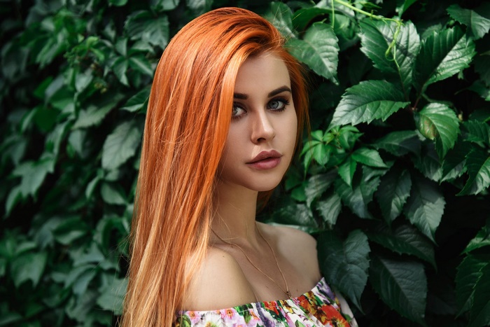 Woman with long orange hair and blue eyes