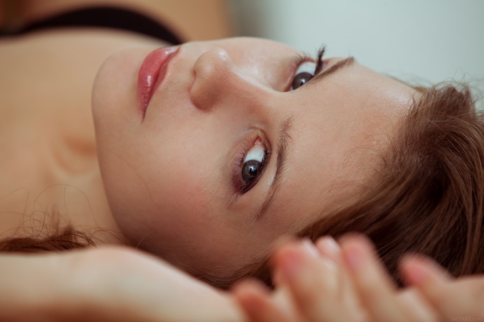 Woman lying down, close-up of face