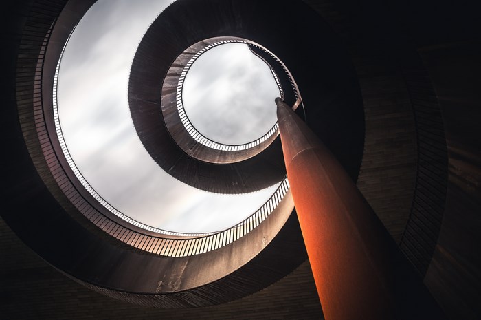 Spiral staircase looking up at the sky