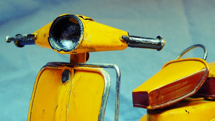 Yellow vintage toy motorbike close-up