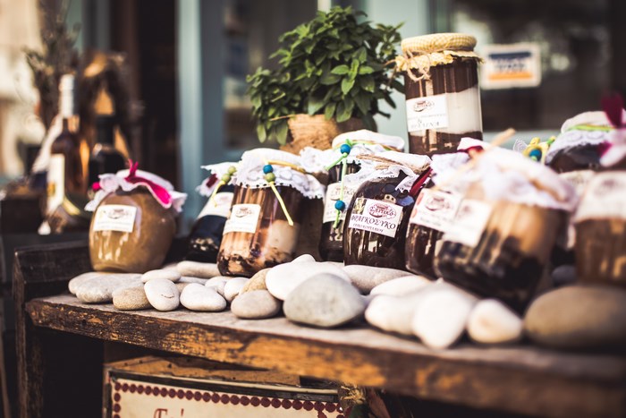 Jars of jam and honey on a wooden stall in Greece