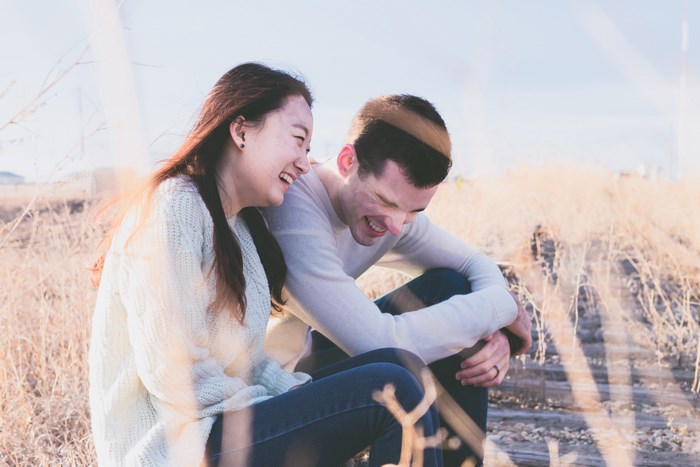 Couple laughing together outdoors