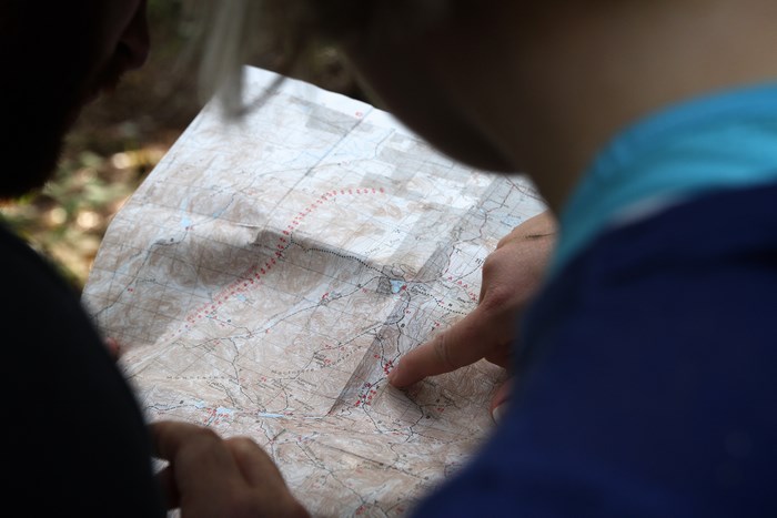 People looking at a map in the Adirondacks