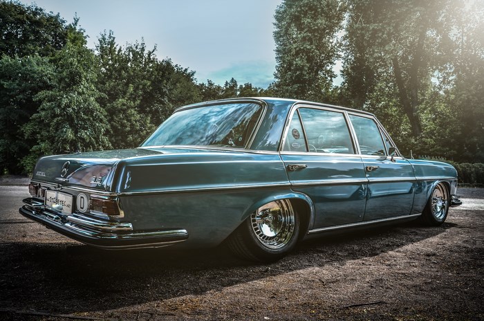 Blue Mercedes-Benz classic car on a dirt road