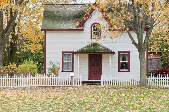 White Cottage with Picket Fence in Autumn