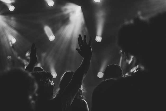 Crowd with hands raised at a concert