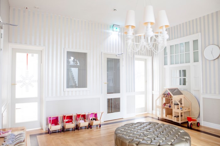 Bright child's room with dollhouse and prams