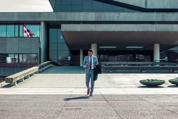 Businessman Walking Confidently Outside Modern Office