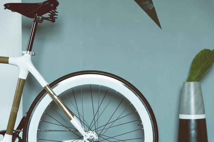 Minimalist bicycle with white frame and bamboo accents