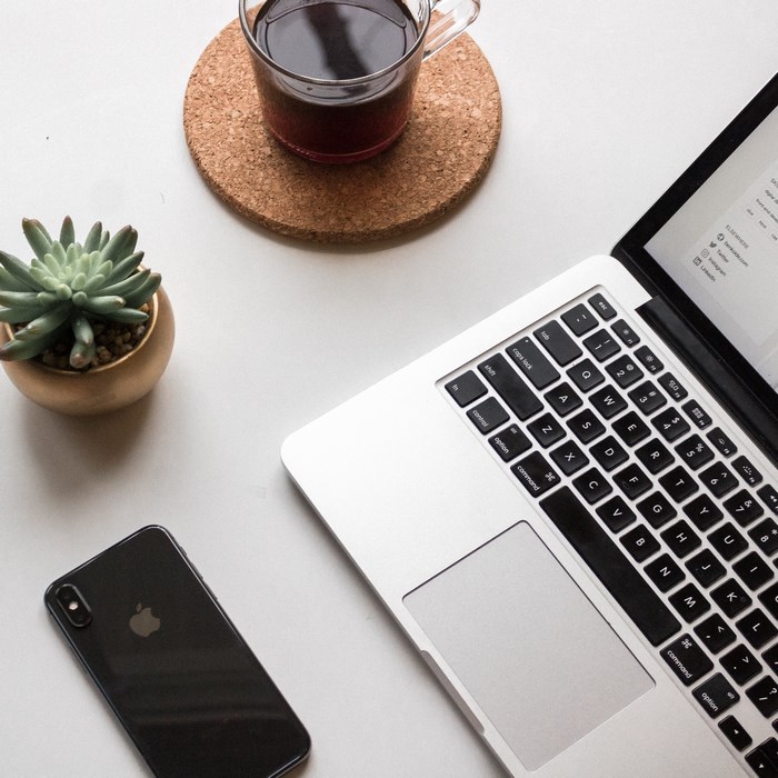 Apple MacBook, iPhone, Coffee, and Plant Flatlay