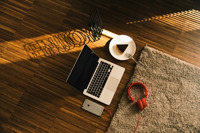 MacBook, iPhone, Cake, Headphones, and Rug on Floor