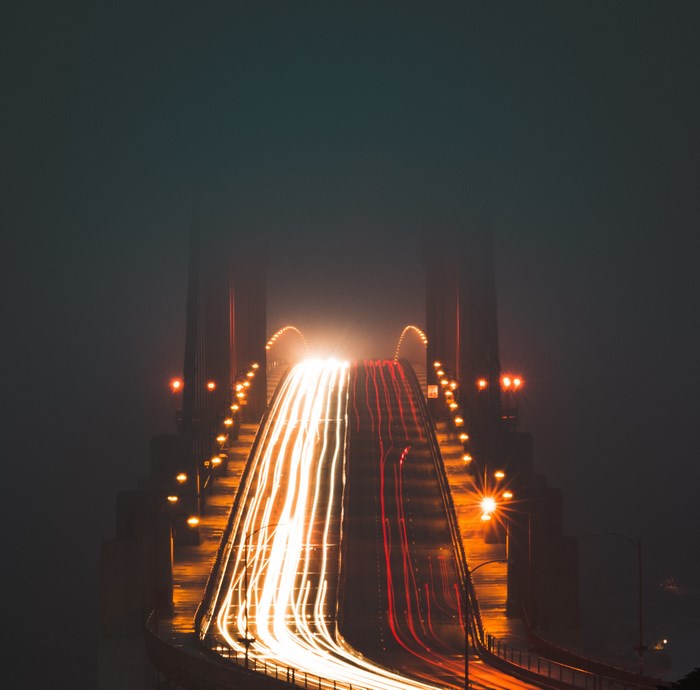 Golden Gate Bridge light trails in fog at night