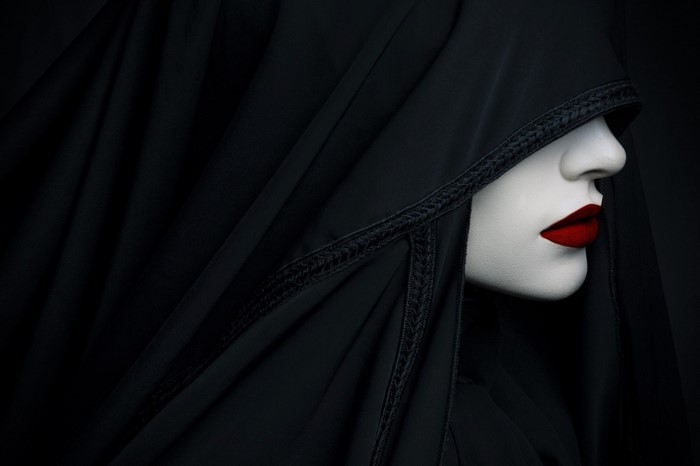Woman in black veil with red lipstick