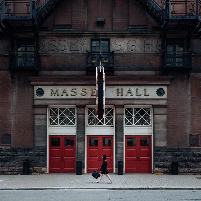Woman walks past Massey Hall in Toronto