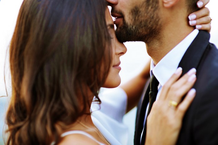 Bride and groom kissing on wedding day
