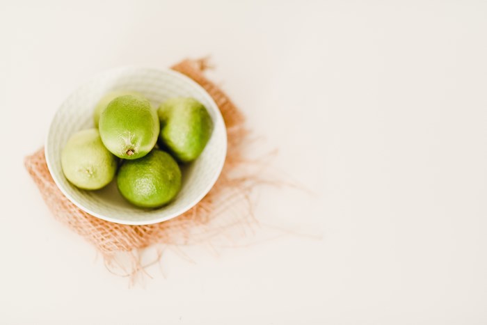 Bowl of Limes on a Mat