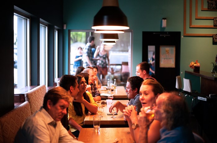 People dining and conversing at tables in a restaurant