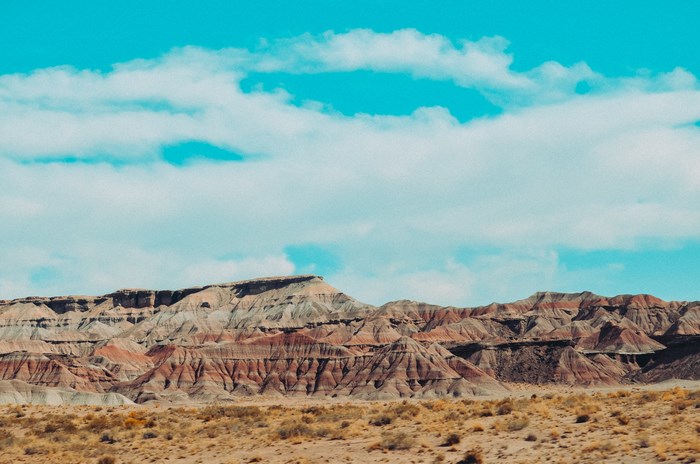 Desert landscape with sandstone mountains and teal sky