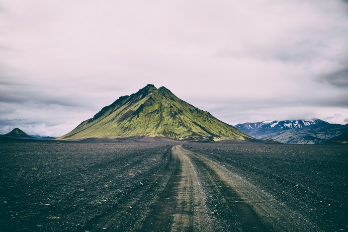 Mossy mountain and dirt road in Iceland