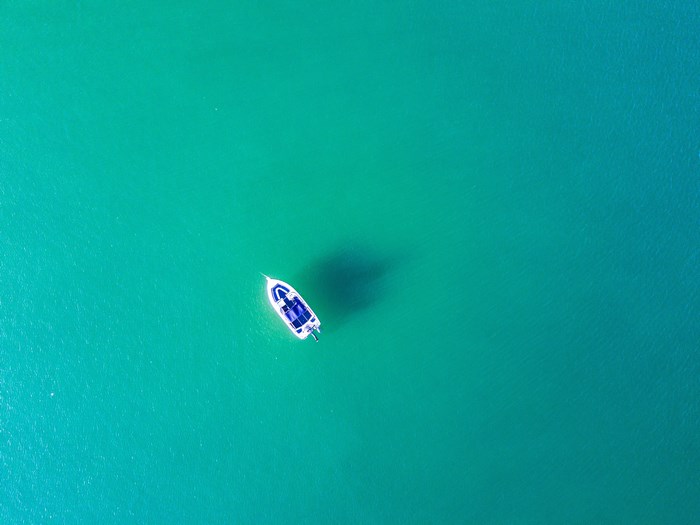Aerial view of a white boat on turquoise water