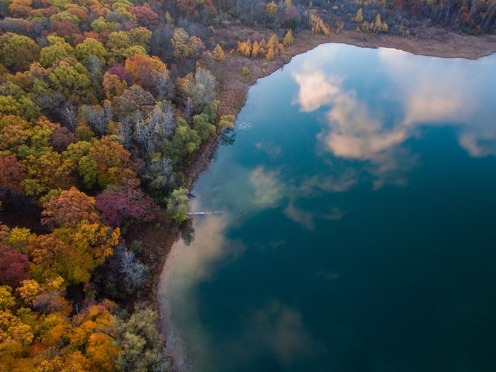 Aerial view of a lake and autumn forest